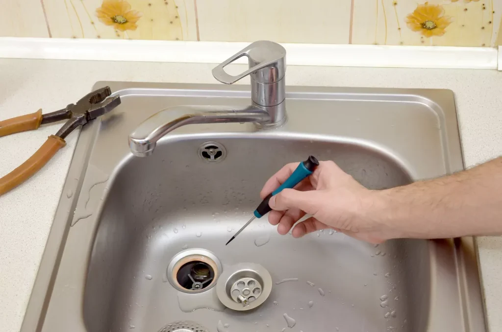 Close-up of plumber repairing drain