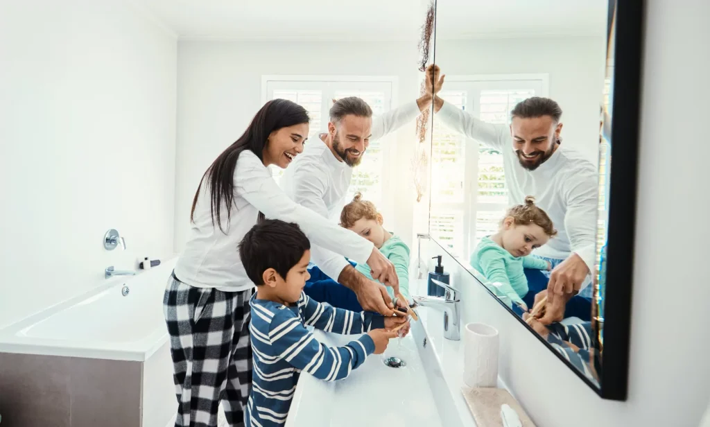 Happy family using the bathroom together