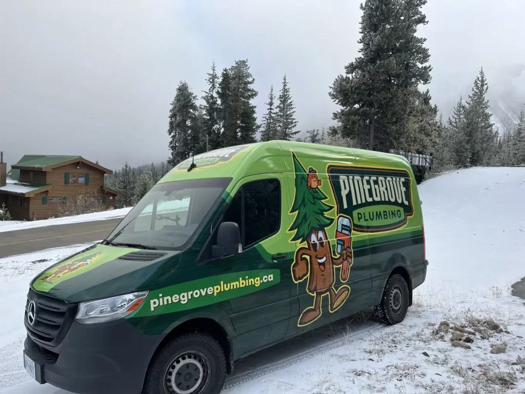 Pinegrove plumbing van next to the road on a snowy day