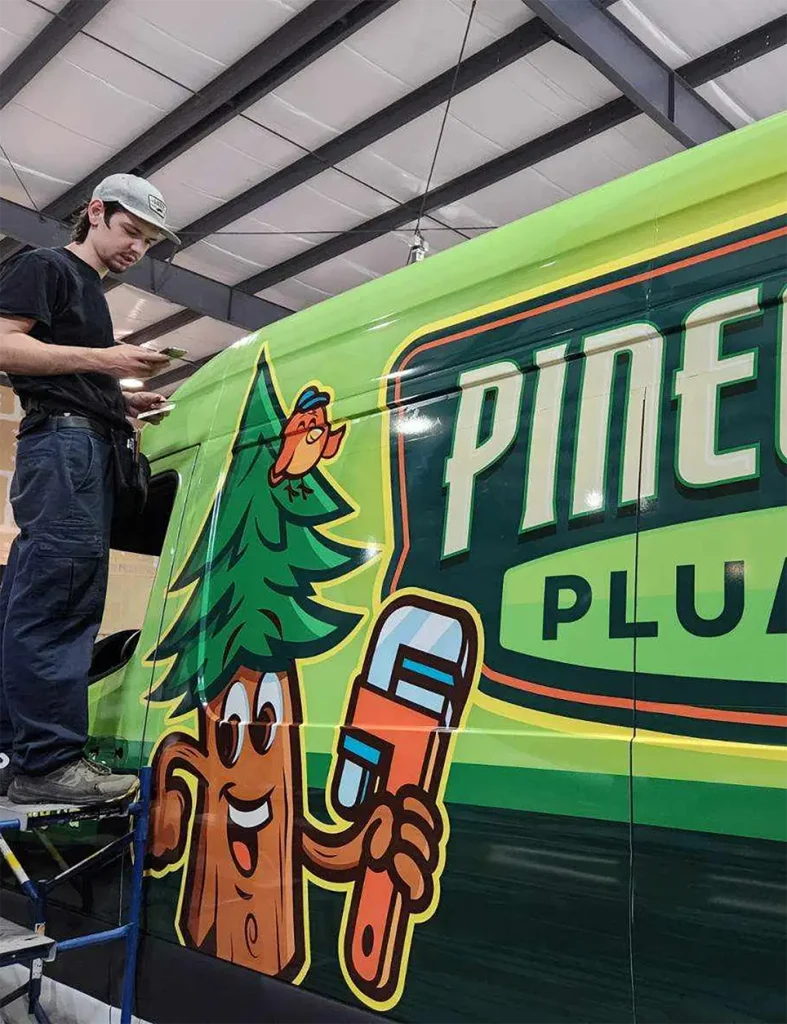 Pinegrove Plumbing professional next to newly wrapped Van