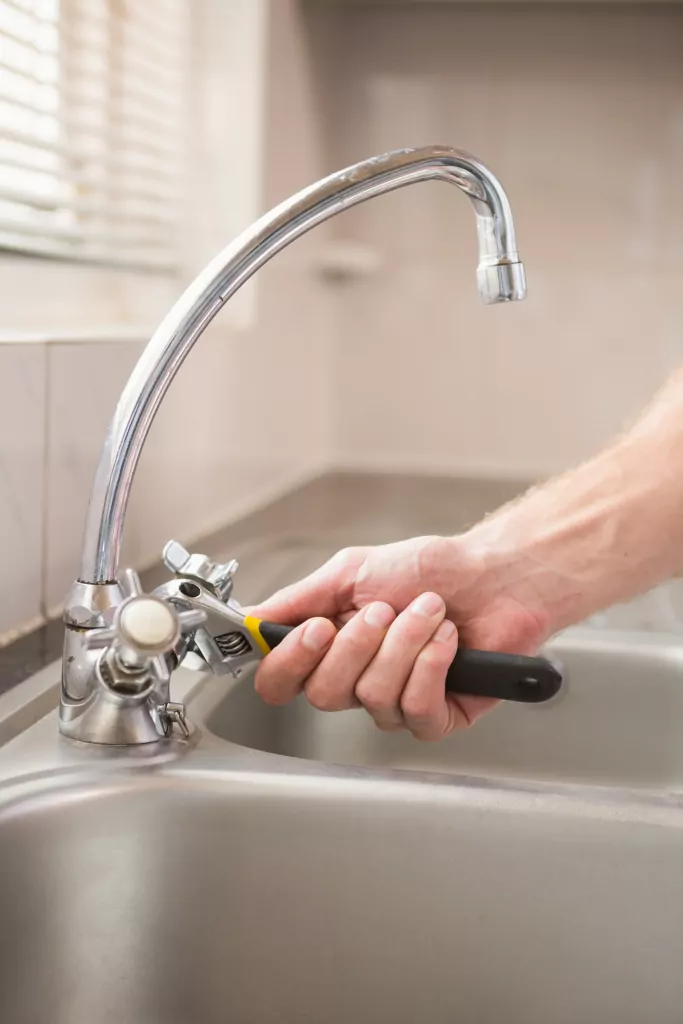 Man fixing faucet