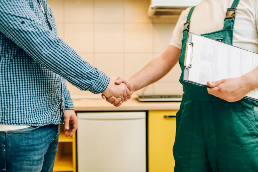 Plumber and customer handshake